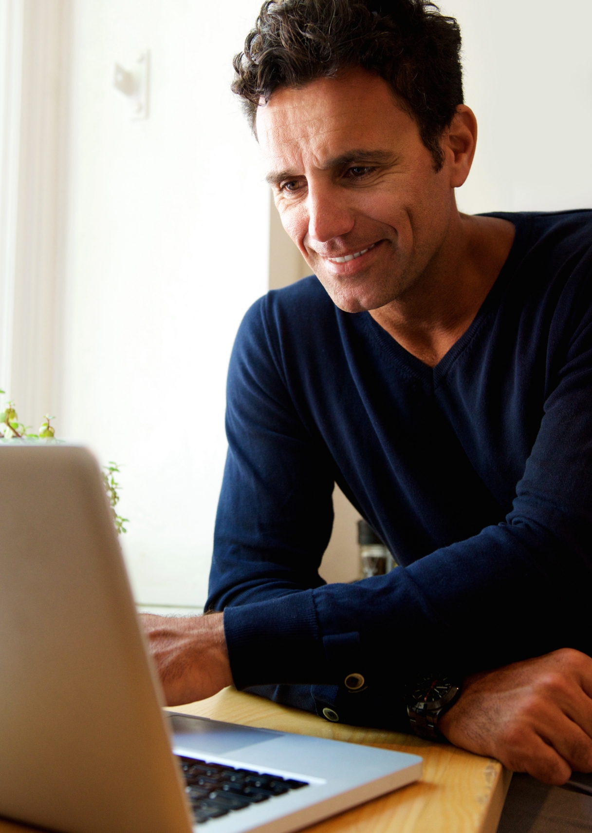 man working on laptop smiling